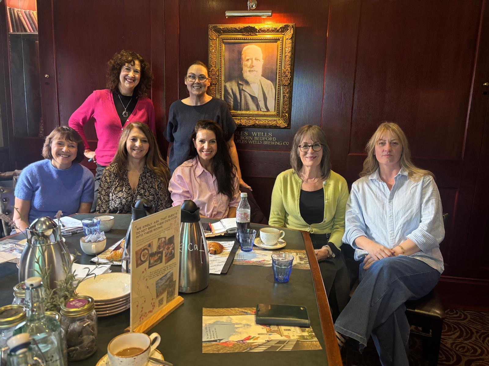 An image with seven women posing for a camera.