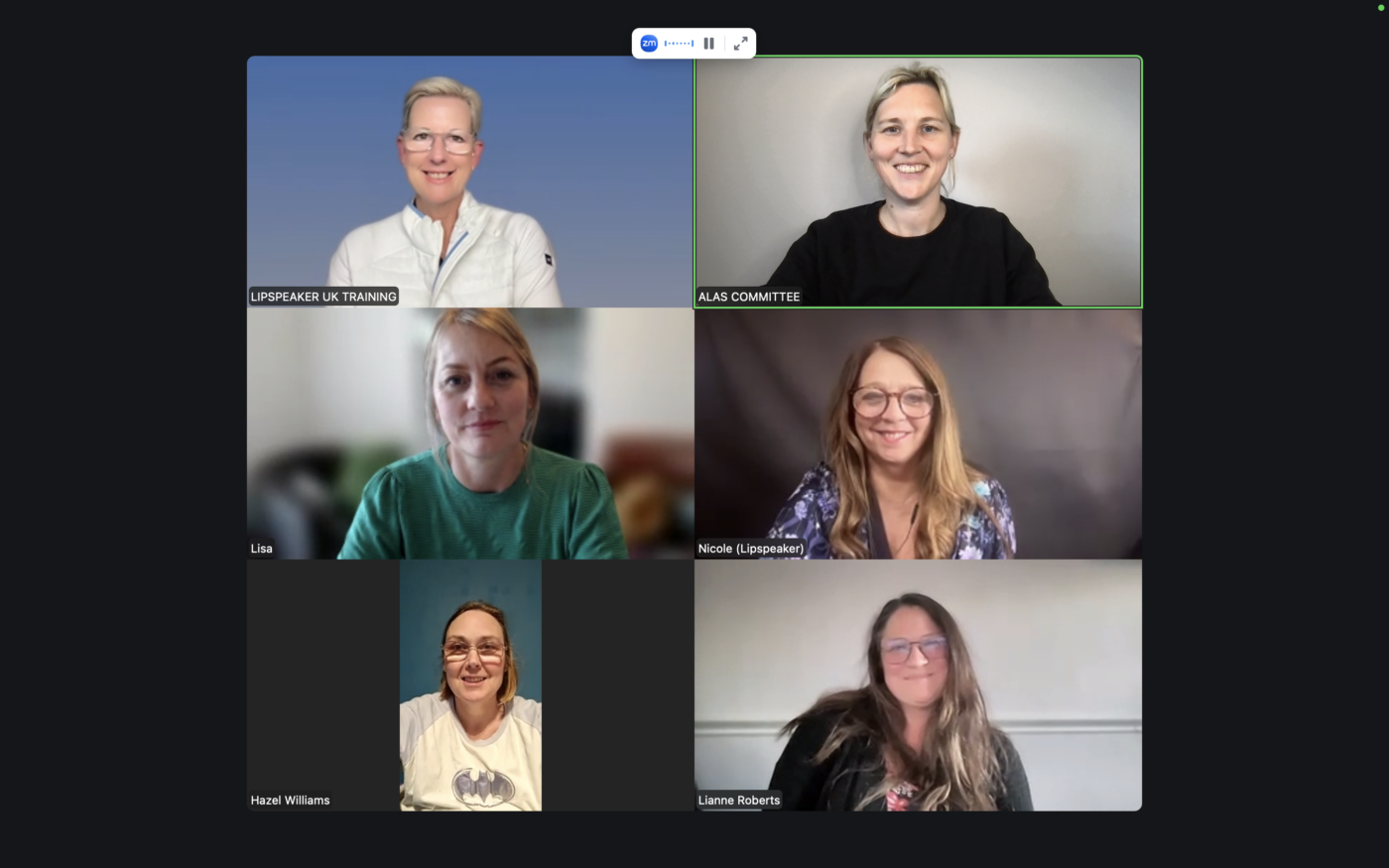 Image of 6 people on a Zoom meeting. All people appear happy and smiling.